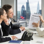 Business meeting in London office with three people discussing feedback form, Union Jack flag and cityscape view